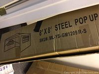 Box labeled 8' x 8' steel pop up canopy with SKU ML-YS-GM1209R-S.
