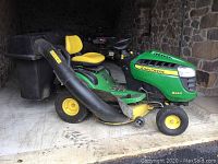 Side view of tractor with grass catcher attached
