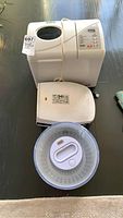 Photo showing the Welbilt ABM3500 bread maker, George Foreman grill, and Zyliss salad spinner together on a table
