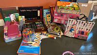 Full view of boxed art supplies: colored pencils, crayons, paints, construction paper, markers, fashion design tote and more.