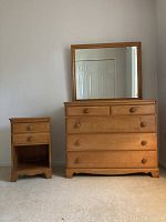 Front view of maple wood dresser with attached framed mirror and matching nightstand showing overall condition.