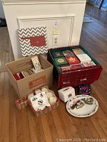 Wide view showing bins, boxes, a framed Oklahoma wooden wall art, a basket with candles, and a decorative Oklahoma plate with ornaments.