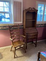 Photo showing maple armchair and small desk with removable hutch next to window.