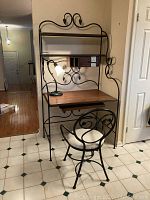 Front view of Stone County Ironworks computer desk with matching chair and desk lamp in a tiled floor room