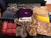 Overview of all scarves including fringed coin scarf, solid purple, gold metallic, yellow, pink-red geometric, leopard, paisley, and animal print scarves.