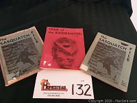 Three books laid out on black fabric surface each related to Sasquatch. Center book is red titled Year of the Sasquatch, side books tan titled The Sasquatch File.