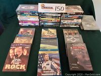 Image showing a large assortment of DVDs and Blu Ray cases arranged on a surface with the lot number card visible.