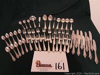 Full layout of flatware pieces including spoons, forks, knives, presenting the entire set.