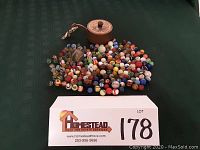 Overhead shot showing pile of glass marbles in assorted colors and the Little Giant pocket radio