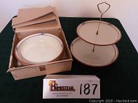 Overview photo showing two-tiered serving tray with brass handle and round baker dish inside box