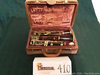 Opened canvas case with disassembled clarinet inside velvet lining