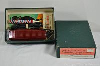 Vintage Oster Model No. 13 Lady Dog electric clipper inside original green box with instruction manual and plastic accessory tube.