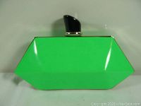Front of the lime green geometric clutch purse with black clasp and silver metal frame