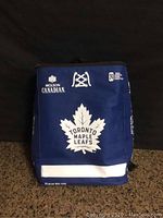 Front view of Toronto Maple Leafs cooler backpack showing team and sponsor logos and blue fabric