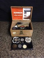Photo showing wooden Ronson shoe shine box open with contents inside, with multiple magnetic shine heads displayed outside box