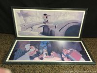 Two framed Disney animation pictures laid out, showing full view of Lady and the Tramp (table scene) and Pinocchio (bridge scene) in black frames.