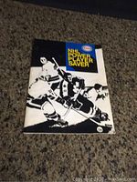 Front cover of the NHL Power Player Saver booklet showing black and white illustration of hockey players and title in blue and yellow.