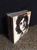 Photo showing stacked vinyl albums with Joe Cocker album cover on front.