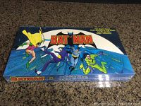 Front side of the sealed Batman board game box showing colorful comic style cover art with Batman and other characters.