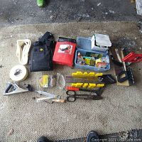 Overview photo showing all tools and items laid out on carpet, including miter box, saw, scissors, planer, respirator, mesh tape, container with hardware, and safety goggles.