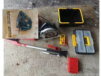 Overview of all tools including circular saw, multimeter, jigsaw box, spirit level, red pry bar, toolbox, and black plastic container.