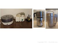 Five kitchen appliances including food dehydrator, juicer, soybean milk machine, milk frother, and walkie talkie set on charging dock.