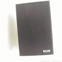 Close-up of one Bose Interaudio Series speaker with fabric front cover and Bose logo label visible.