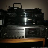 Front view of stacked audio components showing top Pioneer tuner, equalizer, amplifier and bottom Carver amplifier