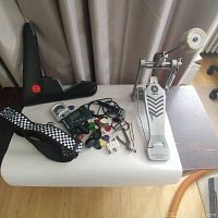 Full lot showing Yamaha drum pedal, digital and clip-on guitar tuners, picks, guitar strap and other accessories, laid out on white surface.