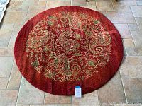 Top view of the round red rug from Safavieh Lyndhurst Collection showing full pattern and size