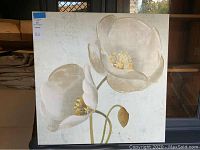 Full view of the white tulip canvas wall art showing the two tulip flowers on a textured light background with some red markings visible.