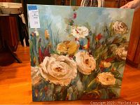 Canvas with impressionistic roses in cream, yellow, and pink with blue-green background.