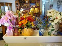 Full view of all five vases with their faux floral arrangements, showing diverse colors and shapes.