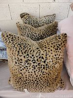 Three 20x20 inch fuzzy leopard print euro pillows stacked together, showing the soft texture and pattern.