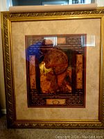 Framed Italian themed print with visible light reflections on glass, ornate gold-tone frame, and double matting