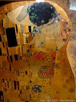 Close-up image of the metallic print showing detailed gold leaf style accents and floral motifs on The Kiss artwork.