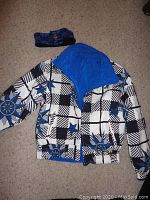 Tyrolia ski jacket with matching headband laid flat to show pattern and colors