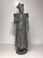 Front view of the Chinese wise man figurine showing detailed clothing and beads.