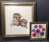 Photo of both framed needlepoint artworks together showing size comparison and condition.