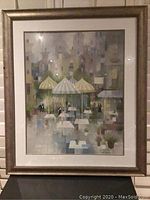 Framed art print titled 'Cafe Montmartre' by Albert Swayhoover showing a street café scene with umbrellas and buildings in the background.