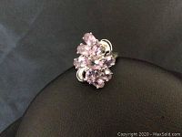 Close-up photo of the sterling silver ring showing multiple light purple amethyst stones in a floral cluster design on a dark background.