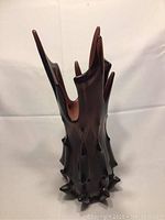 Front view of vintage MCM Viking art glass purple vase with draped and swung form, showing spikes on the glass body.