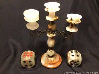Full view of the three-arm onyx candle holder with two onyx dice placed side by side in front.