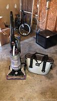 Vacuum and YETI cooler bag side by side on garage floor