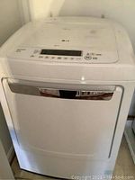 Front view of white LG electric dryer with chrome handle.