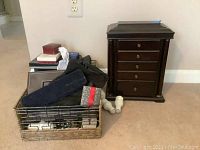 Overall view of jewelry box, baskets and leather case grouped on floor