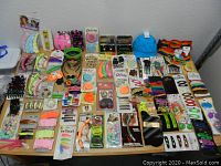 Wide overhead image showing the entire lot spread on a table, featuring hair accessories including headbands, clips, scrunchies, and decorative pins in various colors and packaging states.