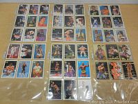 Six pages of 1990 WWF wrestling cards laid out, showing multiple cards featuring Hulk Hogan, Andre The Giant and other wrestlers with colorful imagery and text.