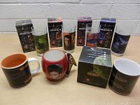 Photo showing all mugs and collectible glasses with packaging arranged on a table.