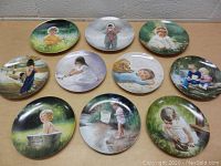 Top-down view of all 10 Zolan collector plates laid on table, showing various child and nature scenes.